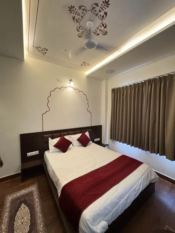 A painted arch and ceiling motif above the bed
